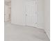 A well-lit bedroom with neutral carpeting and paint, and a door leading to a closet or other room at 3600 Elkhorn Nw Ct, Duluth, GA 30096