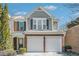 Charming two-story home featuring gray siding, a brick facade, and a convenient two-car garage at 3600 Elkhorn Nw Ct, Duluth, GA 30096
