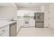 Functional kitchen featuring white cabinets, stainless steel appliances, and ample counter space at 3600 Elkhorn Nw Ct, Duluth, GA 30096