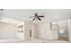 Open-concept living area featuring neutral carpet, a ceiling fan, and seamless flow to the dining area and kitchen at 3600 Elkhorn Nw Ct, Duluth, GA 30096