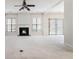 Spacious living room with a fireplace, neutral carpet, large windows, and sliding door access to the backyard at 3600 Elkhorn Nw Ct, Duluth, GA 30096