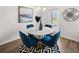 Stylish dining area with elegant blue chairs, a round table, and a modern chandelier at 1326 Magnolia Bend Way # 304, Jonesboro, GA 30238