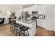 Well-equipped kitchen with white cabinets, granite countertops, and an island with seating at 1326 Magnolia Bend Way # 304, Jonesboro, GA 30238