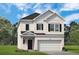 Charming two-story home with white siding, brick accents and an attached two-car garage at 1385 Elowen Dr, Austell, GA 30168