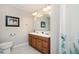 Bathroom featuring a wood vanity with double sinks, tile floors, and framed art at 4349 Highborne Ne Dr, Marietta, GA 30066
