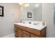 Bathroom featuring a wood vanity with double sinks, tile floors, and framed art at 4349 Highborne Ne Dr, Marietta, GA 30066