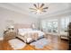 Spacious primary bedroom features a large bed, hardwood floors, and outdoor access to a deck at 4349 Highborne Ne Dr, Marietta, GA 30066