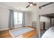 Well-lit bedroom with hardwood floors, bunk beds, ceiling fan, and natural light through the window at 4349 Highborne Ne Dr, Marietta, GA 30066