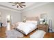 Bright primary bedroom with hardwood floors, ceiling fan, and a stylish, cozy design at 4349 Highborne Ne Dr, Marietta, GA 30066