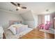Charming bedroom featuring a pink bed, hardwood floors, and lots of natural light from the windows at 4349 Highborne Ne Dr, Marietta, GA 30066