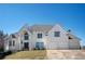 Elegant home with an arched entry, a three-car garage, and a well-maintained lawn under a blue sky at 4349 Highborne Ne Dr, Marietta, GA 30066
