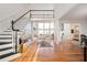 Grand foyer with hardwood floors, staircase, and view into the bright living room with large windows at 4349 Highborne Ne Dr, Marietta, GA 30066