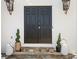 Elegant black double front doors flanked by decorative lanterns and manicured topiaries at 4349 Highborne Ne Dr, Marietta, GA 30066