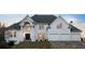 Stately white home featuring a manicured lawn, two-car garage, elegant columns, and a well-maintained landscape at 4349 Highborne Ne Dr, Marietta, GA 30066