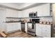 Updated kitchen with white cabinets, stainless steel appliances, and modern backsplash at 4349 Highborne Ne Dr, Marietta, GA 30066