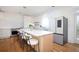 Spacious kitchen features a large island with seating, stainless steel appliances, and access to an outdoor balcony at 4349 Highborne Ne Dr, Marietta, GA 30066
