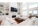 Sunlit living room with built-in bookshelves, a cozy fireplace, and access to an outdoor balcony at 4349 Highborne Ne Dr, Marietta, GA 30066