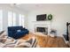 Comfortable living room with hardwood floors, white fireplace, shuttered windows, and stylish furnishings at 4349 Highborne Ne Dr, Marietta, GA 30066