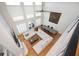 Open living room with a fireplace, built-in shelving, large windows, hardwood floors, and fan at 4349 Highborne Ne Dr, Marietta, GA 30066
