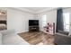 Bright living room featuring hard floors, neutral paint, and access to the bedroom and outdoor balcony at 4349 Highborne Ne Dr, Marietta, GA 30066