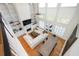 Open living room with a fireplace, built-in shelving, large windows, and hardwood floors at 4349 Highborne Ne Dr, Marietta, GA 30066