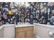 Unique powder room featuring patterned wallpaper, a wooden vanity with a marble countertop, and stylish fixtures at 4349 Highborne Ne Dr, Marietta, GA 30066