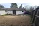 Spacious backyard with a patio, green grass, and a wooden fence. Ready for outdoor enjoyment at 4906 Kellys Mill Nw Dr, Lilburn, GA 30047