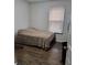 Simple bedroom featuring laminate wood flooring and a window for natural light at 4906 Kellys Mill Nw Dr, Lilburn, GA 30047