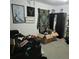 Cluttered bedroom featuring dark furniture, personal items, and artwork at 4906 Kellys Mill Nw Dr, Lilburn, GA 30047