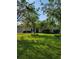 Well-manicured front yard with mature trees and lush green lawn at 4906 Kellys Mill Nw Dr, Lilburn, GA 30047