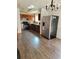 Modern kitchen featuring stainless steel appliances, wooden cabinetry, and sleek flooring for a contemporary culinary experience at 4906 Kellys Mill Nw Dr, Lilburn, GA 30047