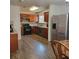 Traditional kitchen with stainless steel appliances, tile backsplash, wood cabinets, and wood flooring at 4906 Kellys Mill Nw Dr, Lilburn, GA 30047