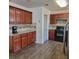 Traditional kitchen with granite counters, stainless appliances, and wood cabinets and flooring at 4906 Kellys Mill Nw Dr, Lilburn, GA 30047