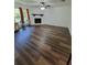 Bright living room featuring modern flooring, fireplace, and natural light, ideal for relaxation and entertainment at 4906 Kellys Mill Nw Dr, Lilburn, GA 30047