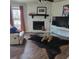 Inviting living room with stone fireplace, leather furniture, and hardwood floors at 4906 Kellys Mill Nw Dr, Lilburn, GA 30047
