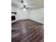Spacious living room featuring modern flooring, a cozy fireplace, and a ceiling fan for added comfort at 4906 Kellys Mill Nw Dr, Lilburn, GA 30047