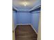 Large main closet with shelving and dark, wood-look flooring at 4906 Kellys Mill Nw Dr, Lilburn, GA 30047