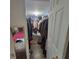 Spacious walk-in closet filled with clothing and storage solutions, connected to the bedroom at 4906 Kellys Mill Nw Dr, Lilburn, GA 30047