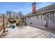 Large backyard wooden deck, fenced perimeter, gray siding and well-manicured lawn at 1923 Rugby Ave, Atlanta, GA 30337