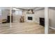 Cozy finished basement area featuring a white fireplace, hardwood flooring and painted support beams at 1923 Rugby Ave, Atlanta, GA 30337