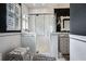 Stylish bathroom with a glass shower, and a white decorative mirror against dark wallpaper at 1923 Rugby Ave, Atlanta, GA 30337