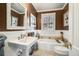 Charming bathroom featuring wainscoting, tile floor, and a white vanity at 1923 Rugby Ave, Atlanta, GA 30337