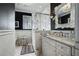 This bathroom offers a glass shower, sleek white vanity, and black and white decor at 1923 Rugby Ave, Atlanta, GA 30337