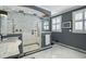 Elegant bathroom featuring marble vanity, walk-in shower with dual showerheads, and white-and-black tiling at 1923 Rugby Ave, Atlanta, GA 30337