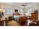 Comfortable bedroom with a cozy rug, ceiling fan, and an abundance of natural light from shuttered windows at 1923 Rugby Ave, Atlanta, GA 30337
