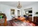 Well-lit dining room adjacent to the living area with hardwood floors, a chandelier, and comfortable seating at 1923 Rugby Ave, Atlanta, GA 30337
