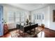 Bright dining room with hardwood floors and large windows offering natural light and outdoor views at 1923 Rugby Ave, Atlanta, GA 30337