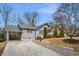 Charming single-Gathering home with a spacious front yard, a driveway with a carport, and traditional landscaping at 1923 Rugby Ave, Atlanta, GA 30337