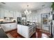 A view of the kitchen featuring a center island with black granite countertop and stainless steel appliances at 1923 Rugby Ave, Atlanta, GA 30337
