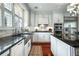 Bright kitchen featuring stainless steel appliances, white cabinets, and black granite countertops at 1923 Rugby Ave, Atlanta, GA 30337
